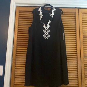 Black sleeveless dress with white embroidered neck detailing